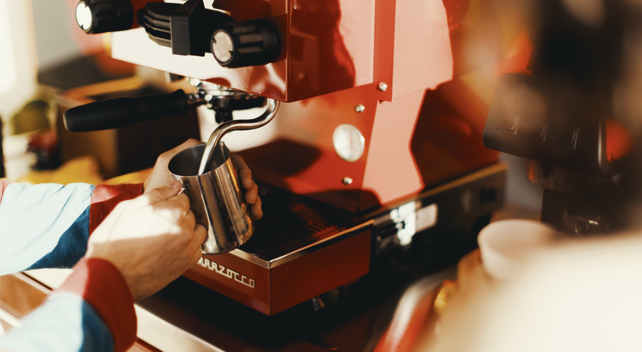 Pulling espresso with La Marzocco Linea Micra in red, detail view of portafilter and group head